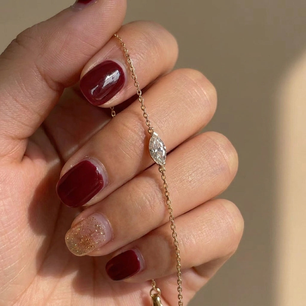 Delicate gold bracelet with faceted oval stone