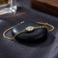 Gold oval stone bracelet with zircon