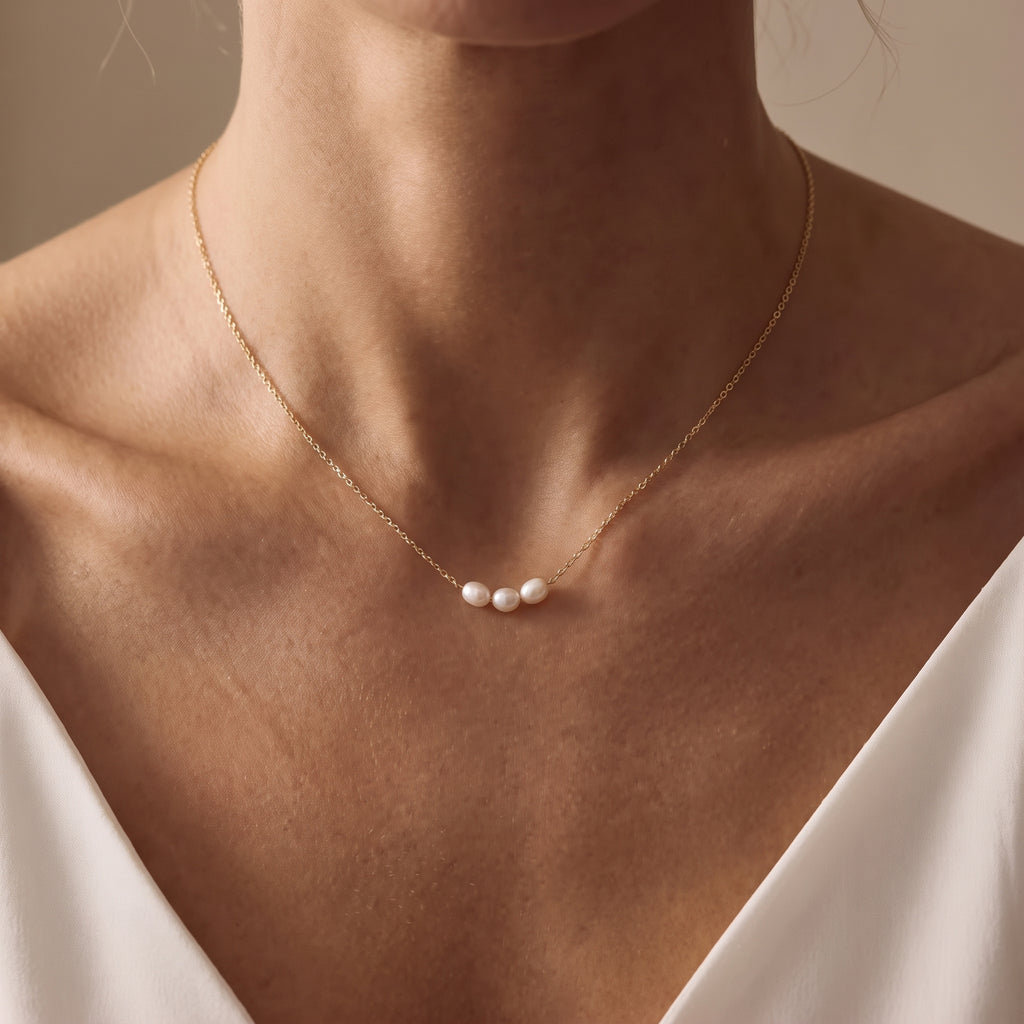 Three pearl necklace with gold plated chain